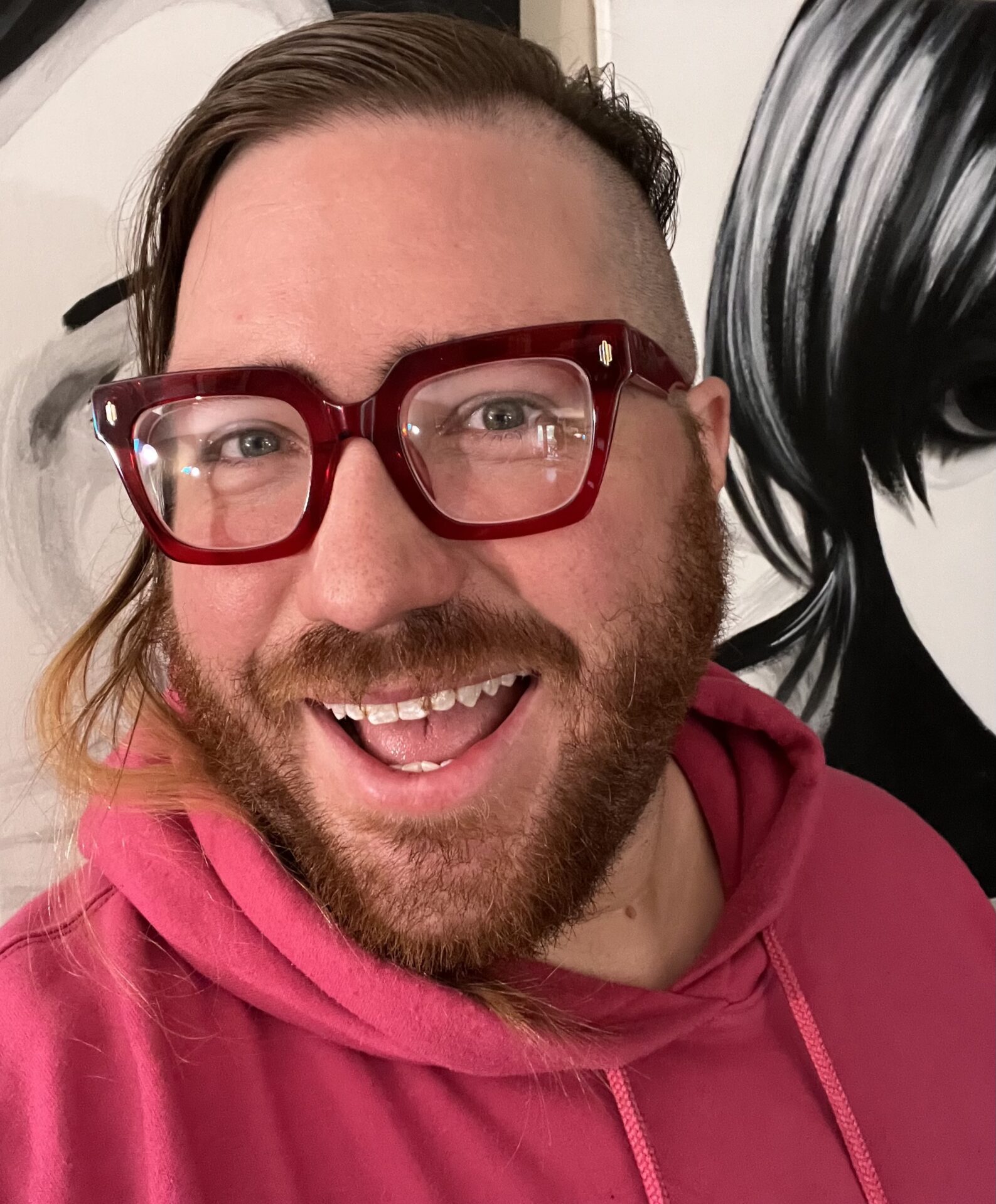 A photo of F. David Schultz. He has a wide smile and wearing bright pink.